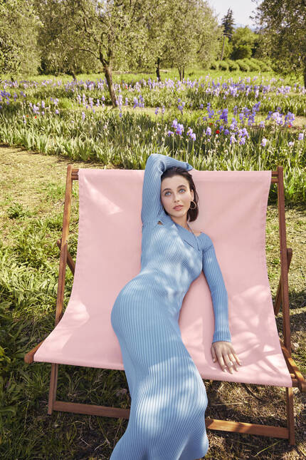 Model in a pink chair at Domaine de la Rose