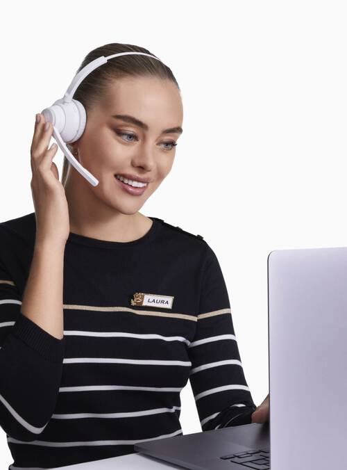 Model wearing a headpiece with a laptop