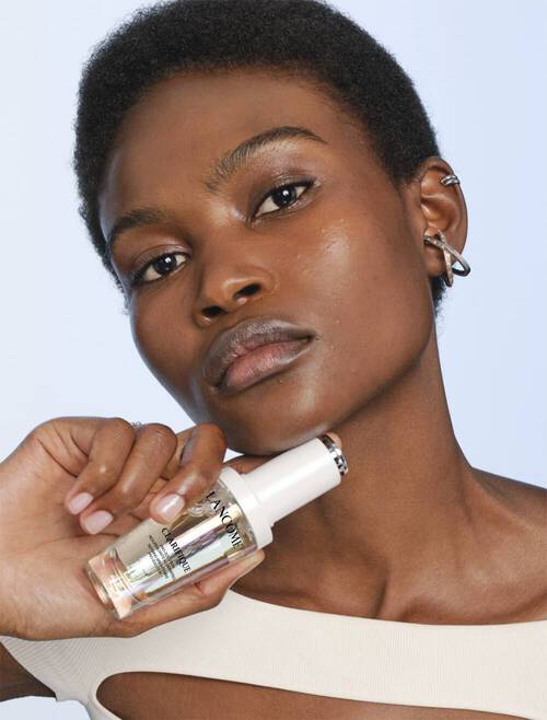 Model posing Clarifique face serum